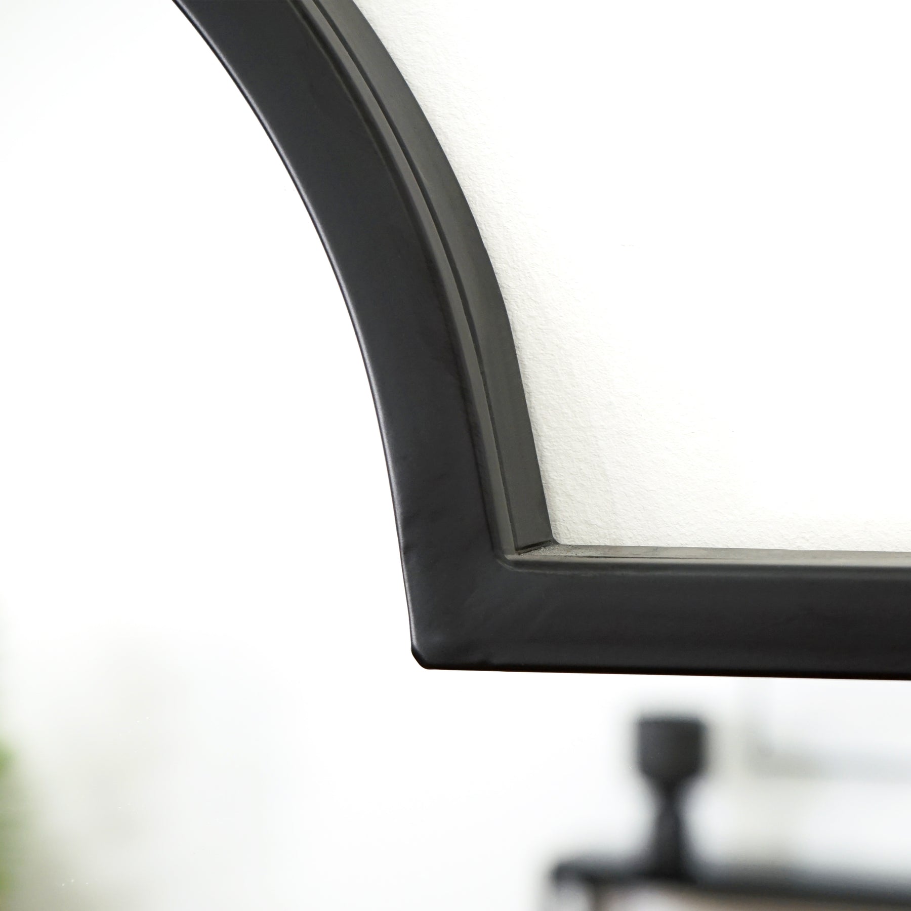 Full length black industrial arched metal mirror detail shot of arch