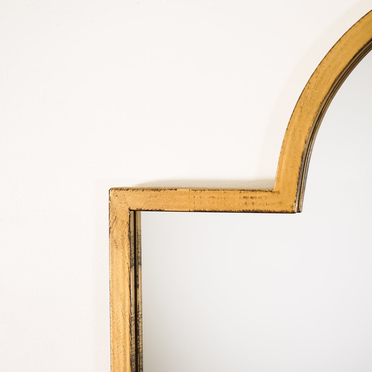 Full length gold industrial arched metal mirror corner