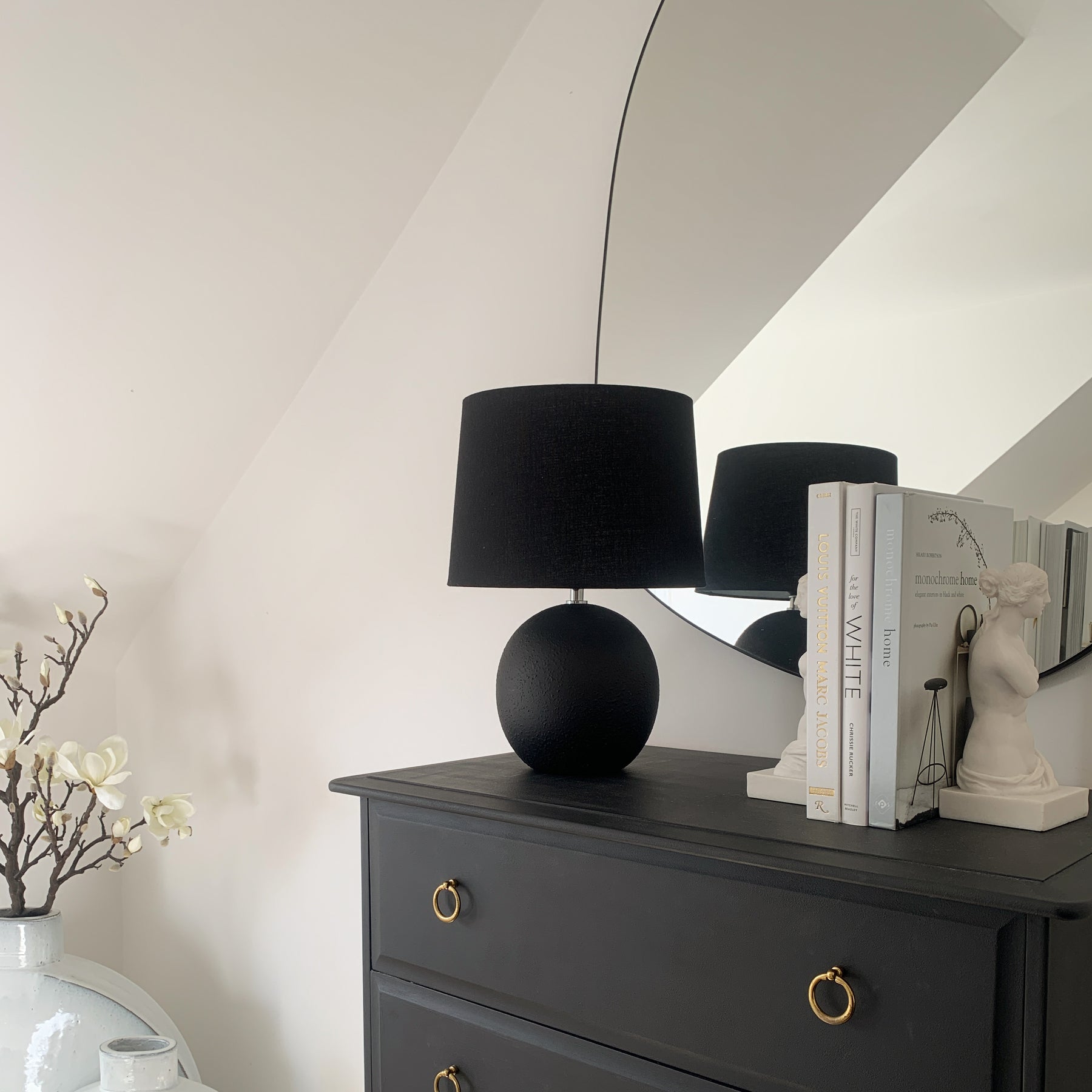 Black ceramic table lamp on console table