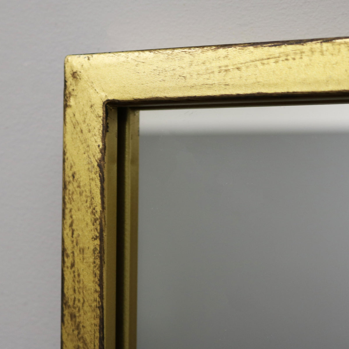 Detail shot of Full length large gold industrial metal window mirror corner