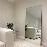 Large Frameless Full Length Rectangular Mirror beside sofa