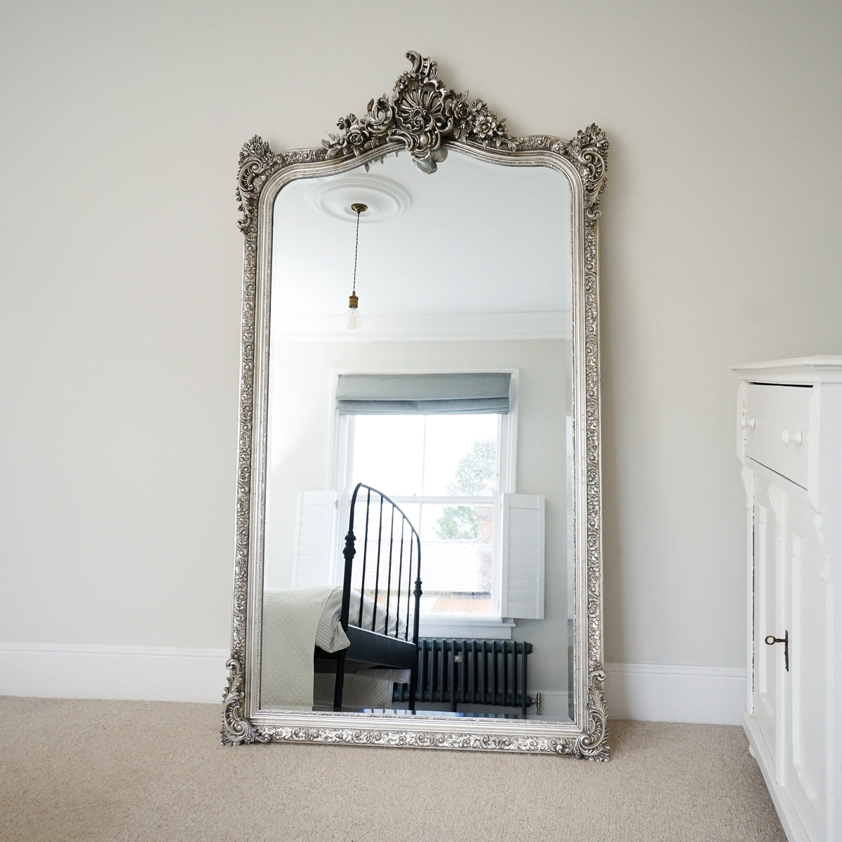 Silver Arched Ornate Full Length Mirror leaning against wall