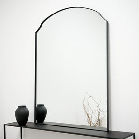 Black Arched Metal Overmantle Wall Mirror leaning against wall