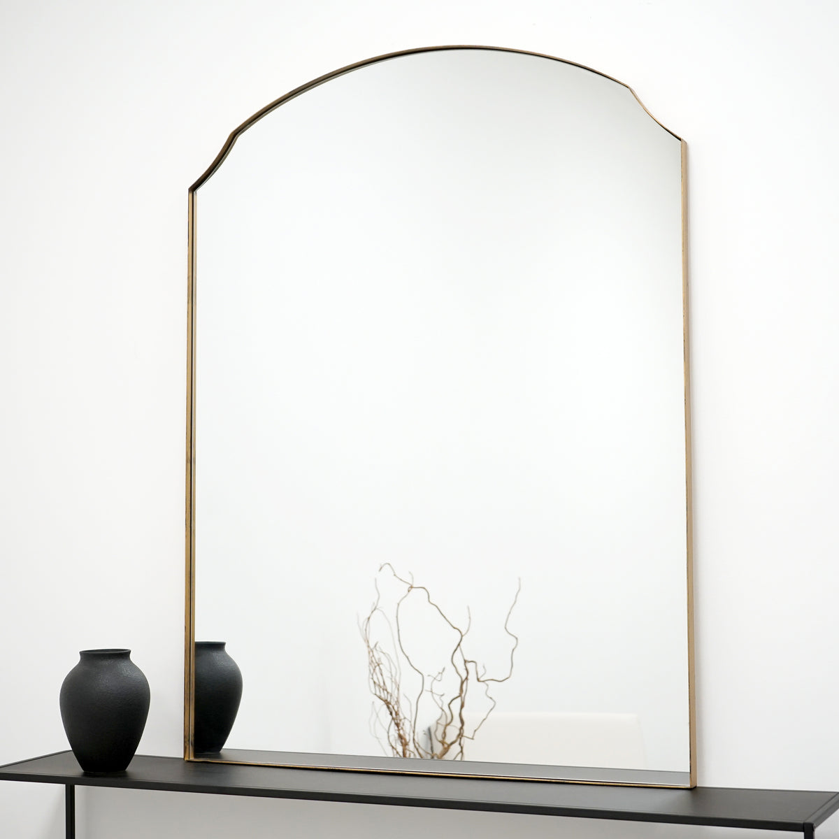 Gold Arched Metal Overmantle Wall Mirror on console table