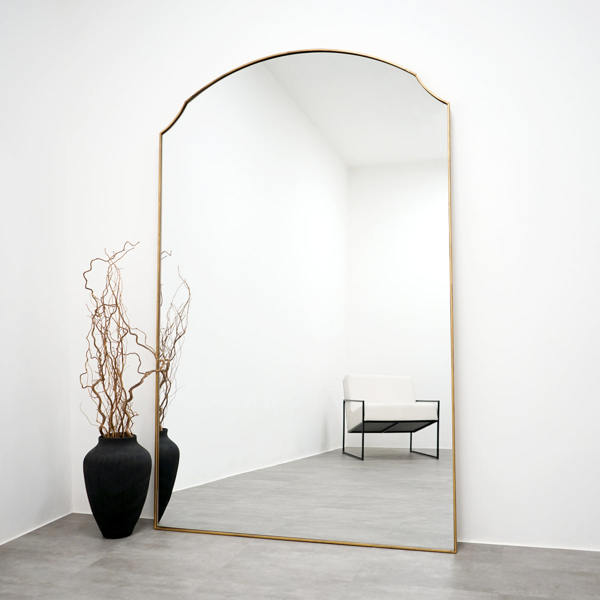 Gold Full Length Arched Metal Mirror leaning against wall
