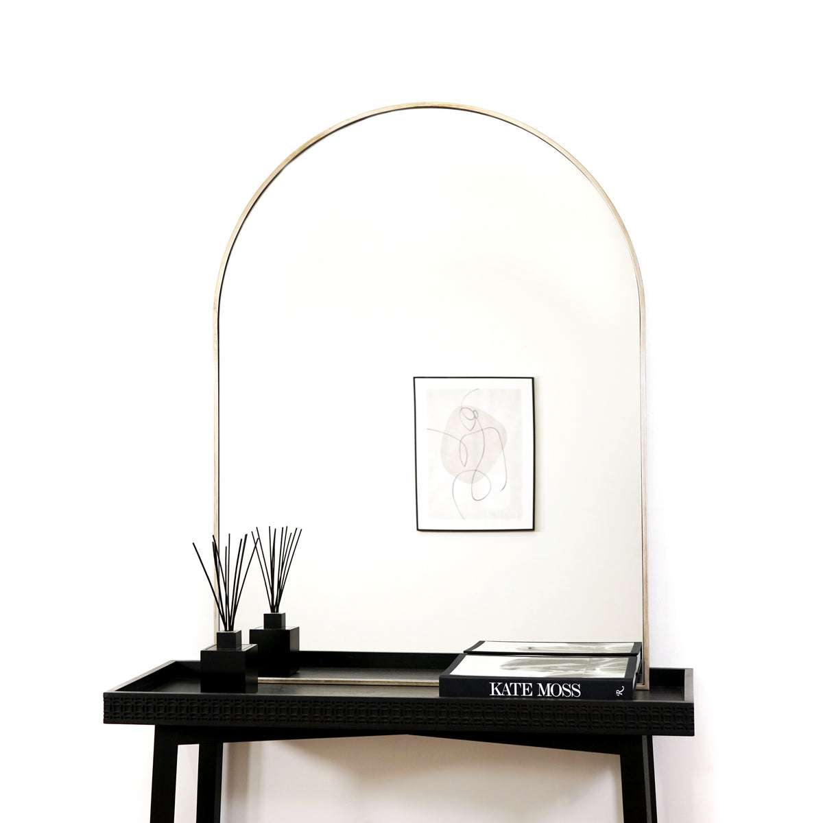 Champagne Arched Metal Overmantle Mirror on console table