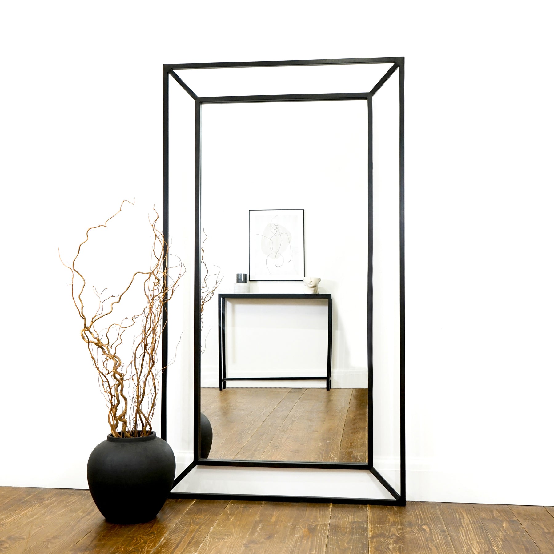 Black Full Length Art Deco Metal Mirror displayed as a living room lean to
