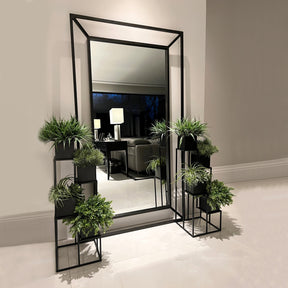 Black Full Length Art Deco Metal Mirror among a variety of potted plants