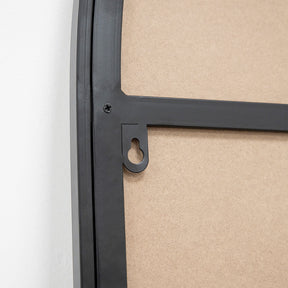 Full length arched black large metal mirror contains hooks for easy wall setup