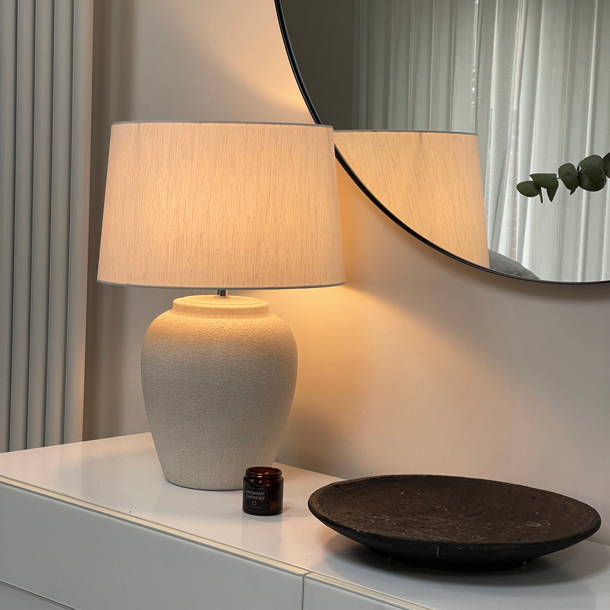 Stone Ceramic Drum Shade Table Lamp emitting warm lighting