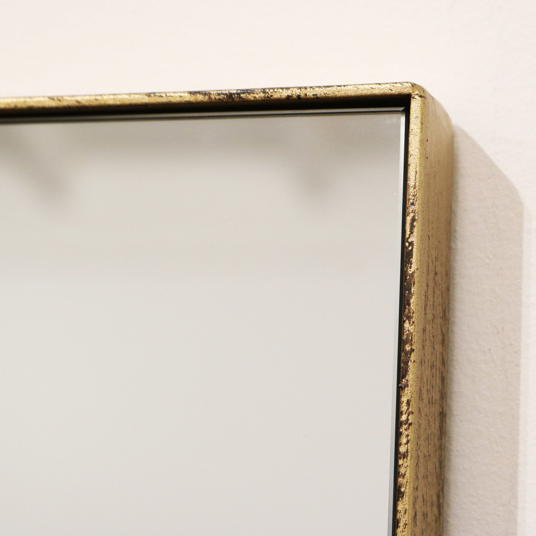 Detail shot of Gold Rectangular Metal Wall Mirror top corner