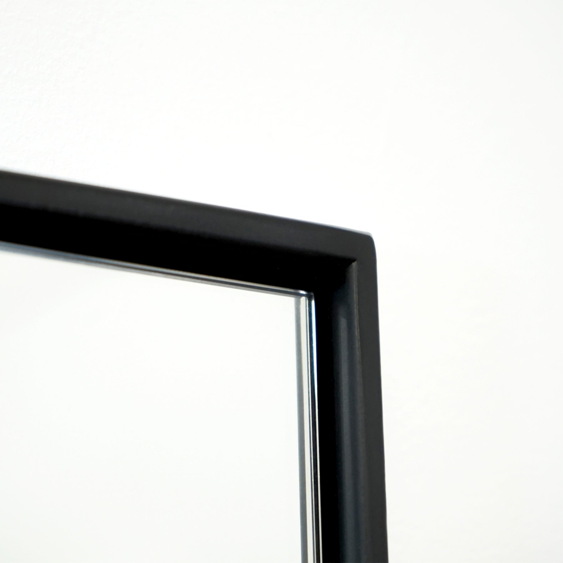Closeup of Full Length Black Extra Large Metal Mirror corner