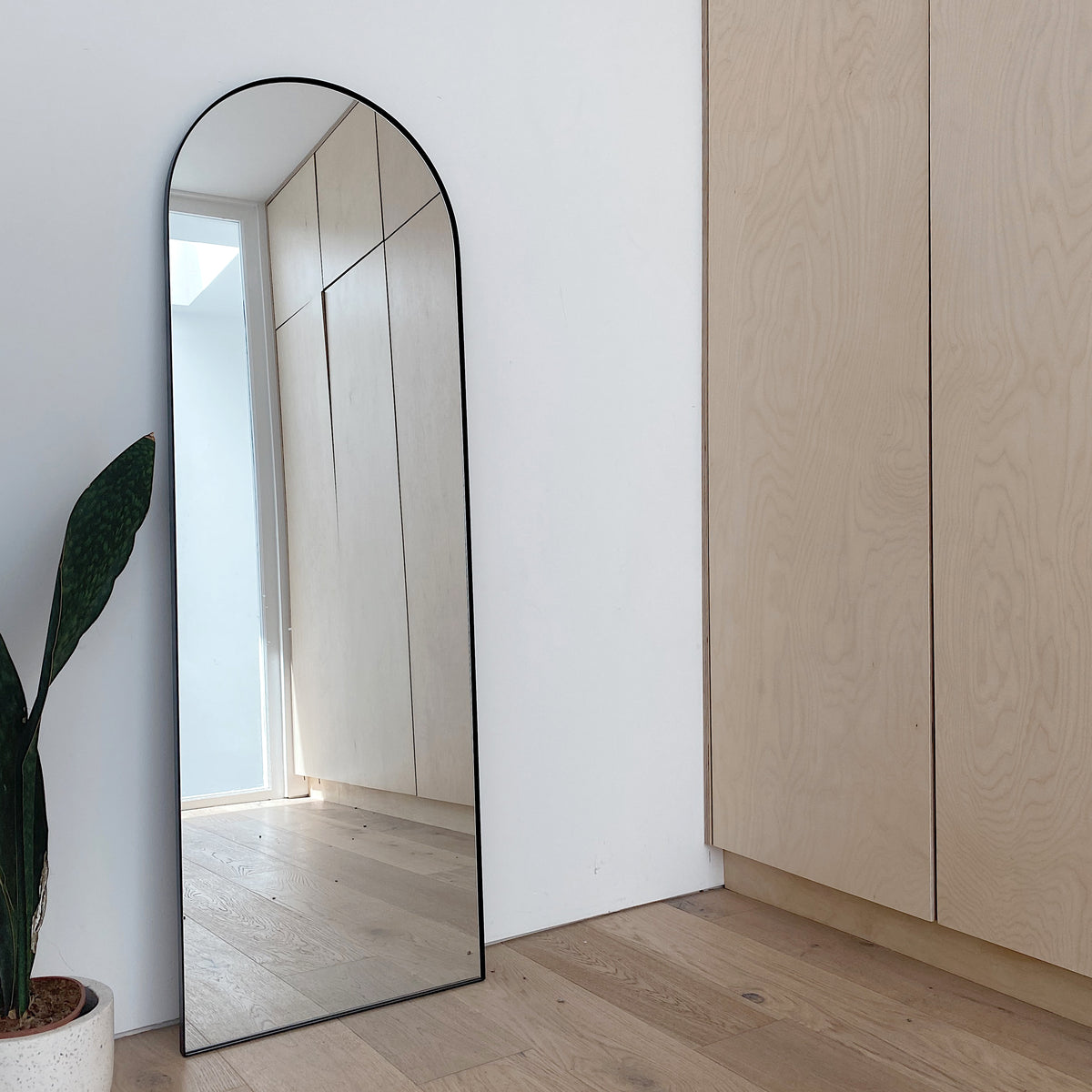 Full Length Black Arched Large Metal Mirror beside cupboard