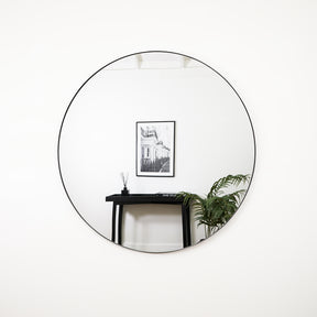 Black Round Metal Extra Large Wall Mirror opposite painting