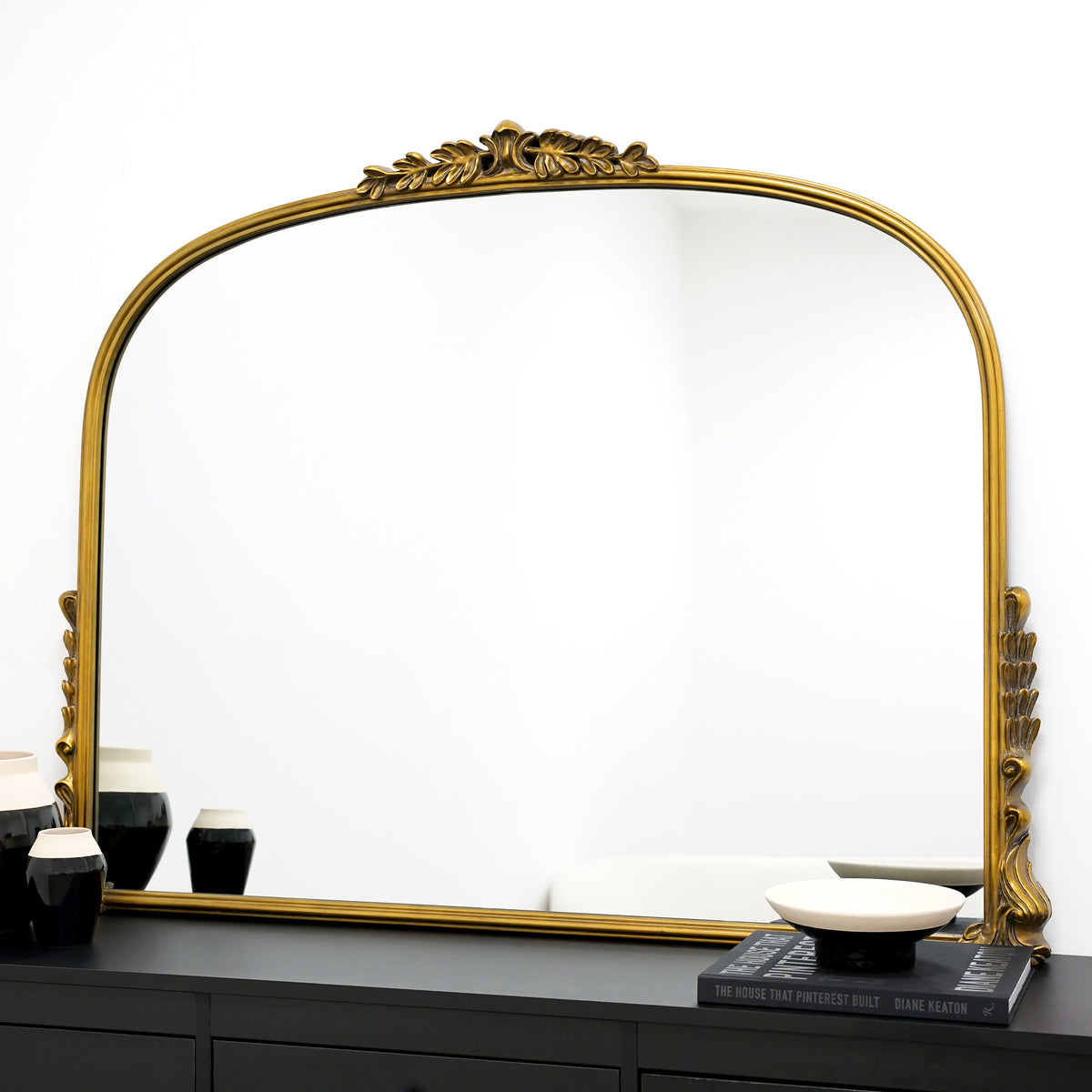 Gold Arched Metal Overmantle Mirror on console table
