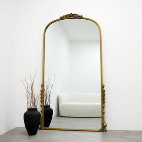 Full Length Gold Arched Ornate Metal Mirror leaning against wall