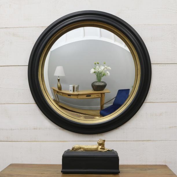 Black and gold porthole fish eye round mirror focus on convex reflection