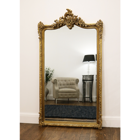 Gold Arched Ornate Full Length Mirror leaning against wall
