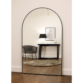 Black Full Length Arched Metal Mirror reflecting lounge