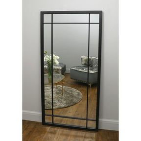 Black Industrial Full Length Metal Mirror leaning against wall in lounge
