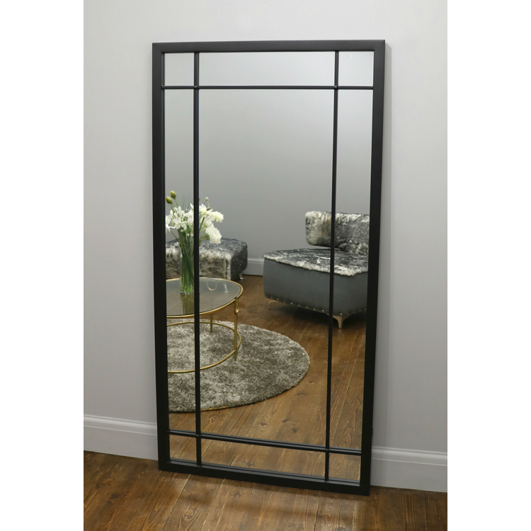 Black Industrial Full Length Metal Mirror leaning against wall in lounge