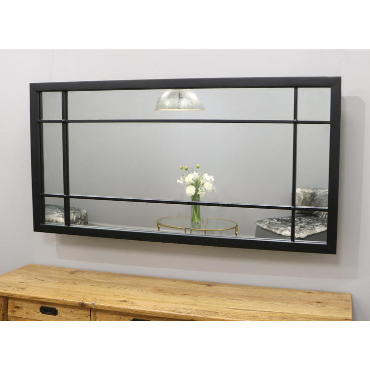 Black industrial metal console mirror displayed above console table