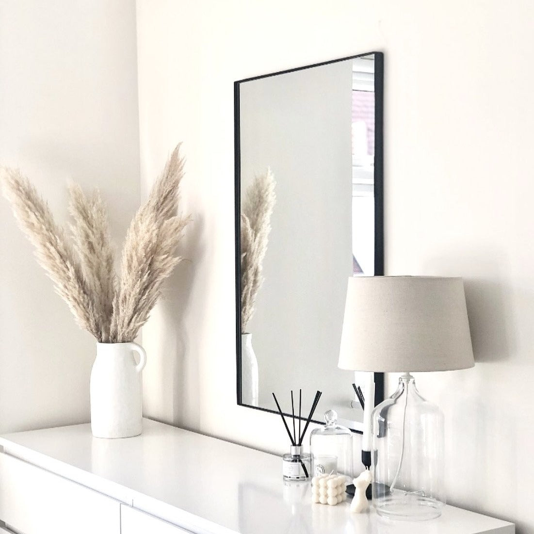 Black Rectangular Metal Wall Mirror above console table