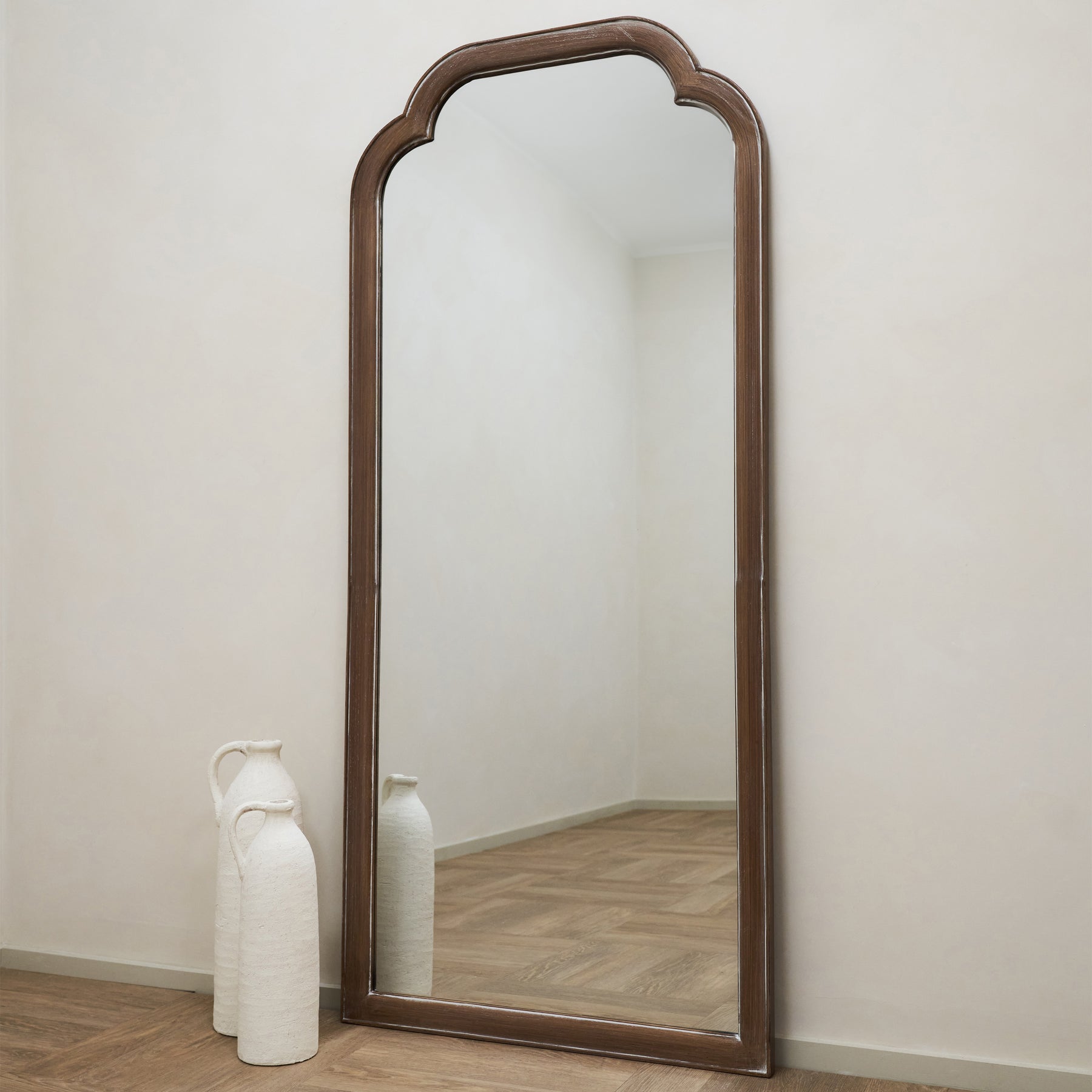 Full Length Washed Wood Arched Mirror next to ceramic vases