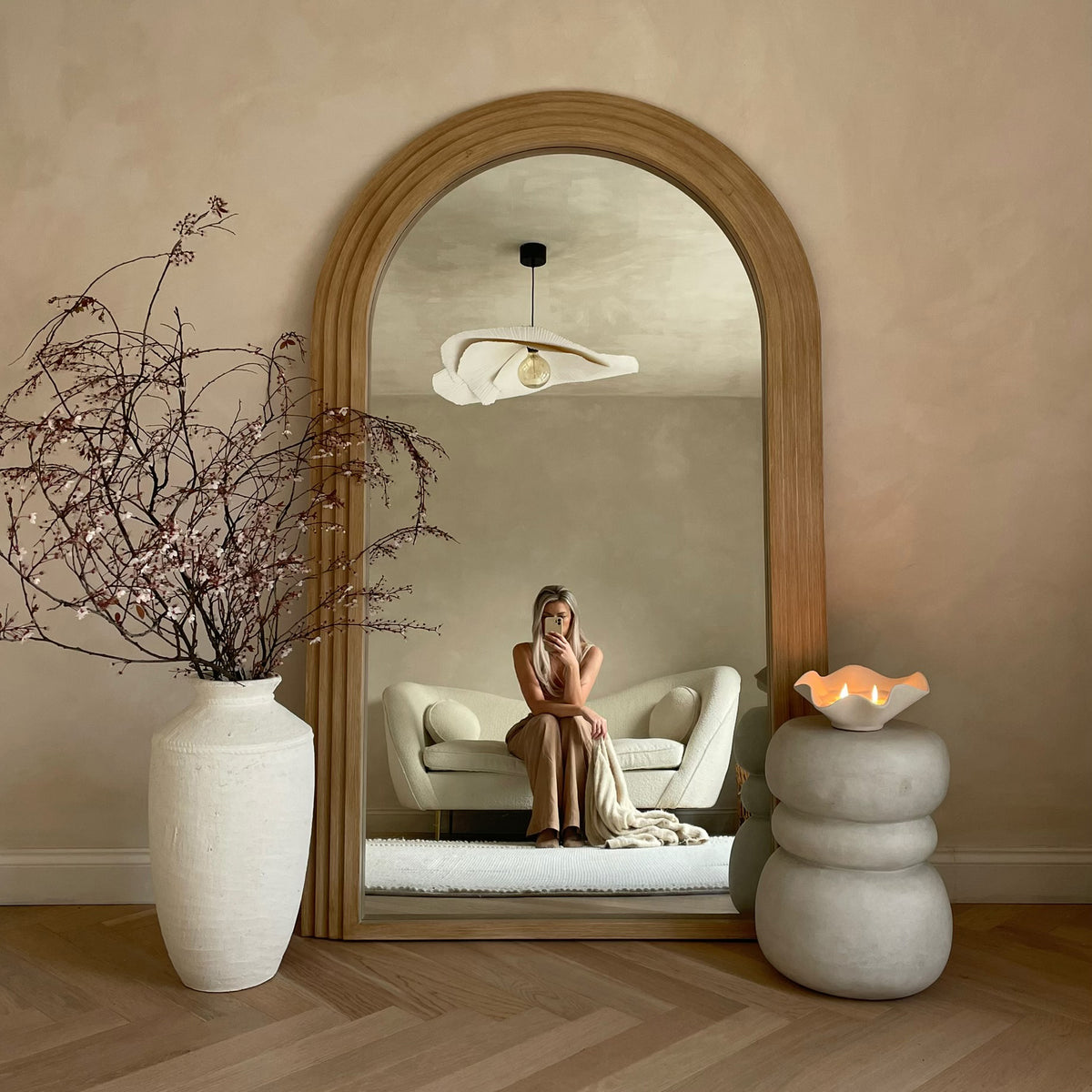 Full Length Arched Washed Wood Mirror nestled amongst ceramics