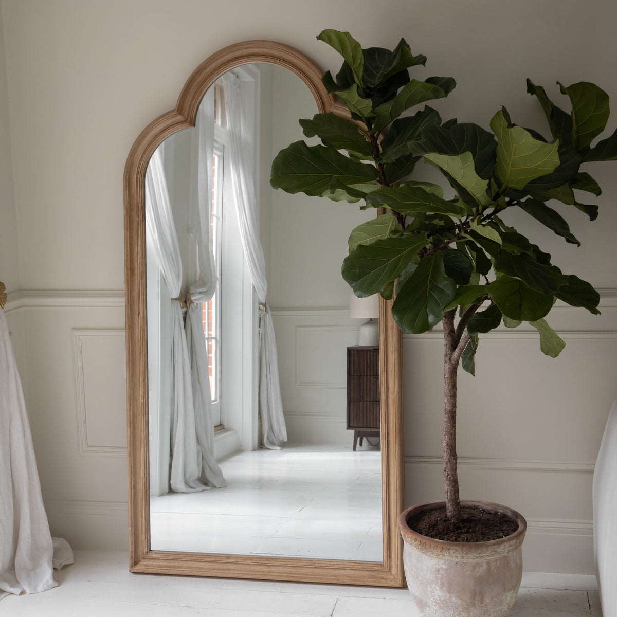 Washed Wood Arched Full Length Mirror beside plant pot