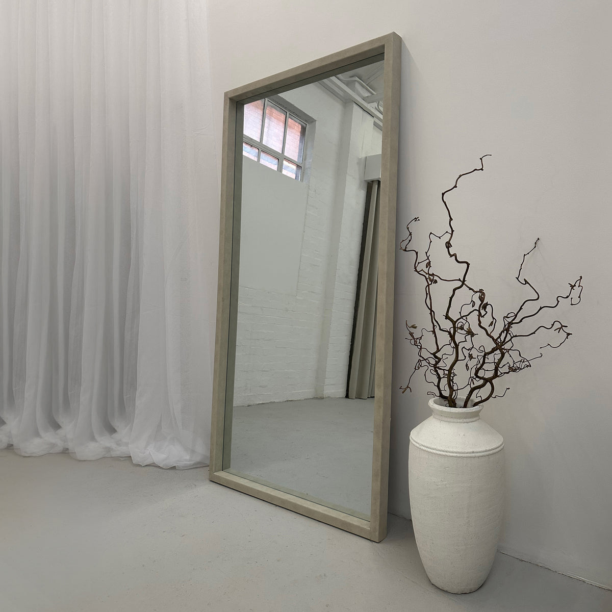 Full Length Extra Large Rectangular Concrete Mirror beside vase