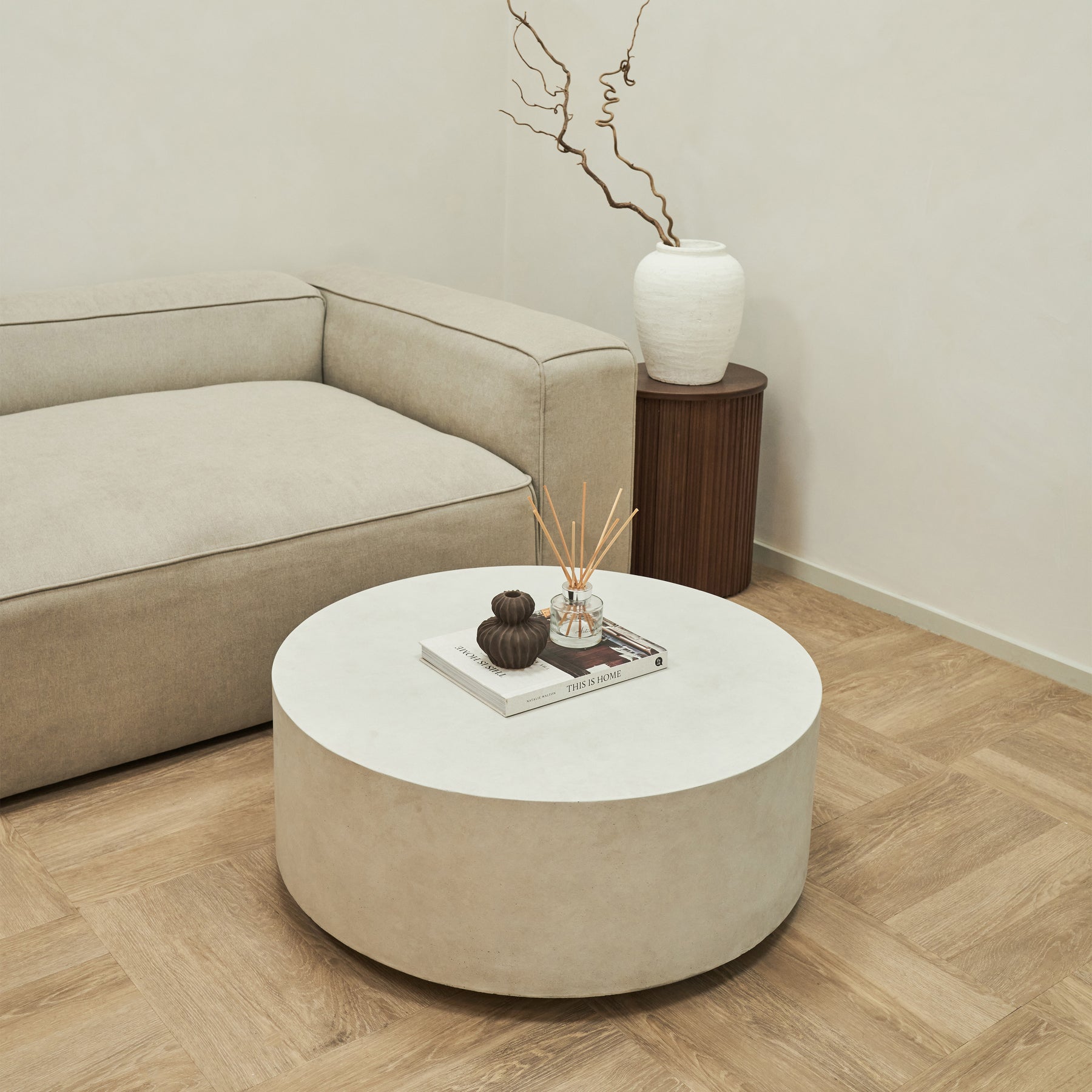 Large minimalist concrete round coffee table displayed in living room