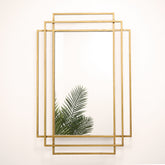 Gold rectangular art deco metal mirror displayed on wall