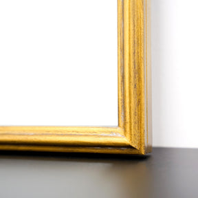 Closeup of Full length gold arched metal mirror