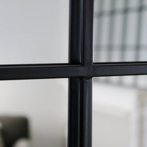 Closeup of Black industrial arched metal window mirror frame