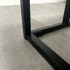 Closeup of Black modern large rectangle tinted mirrored coffee table stand