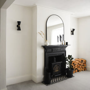 Black Arched Metal Overmantle Mirror on mantlepiece