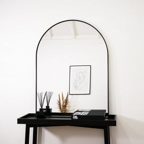 Black Arched Metal Overmantle Mirror on console table