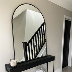 Black Arched Metal Overmantle Mirror leaning against wall