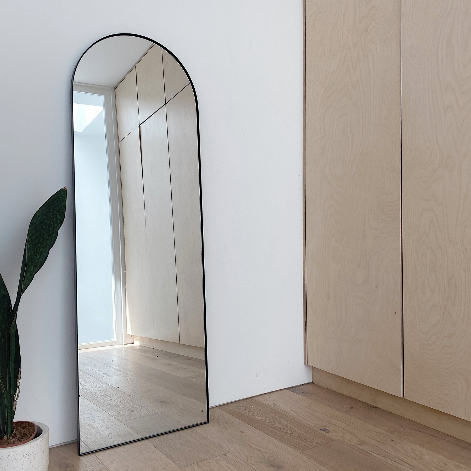 Full Length Black Arched Large Metal Mirror leaning against wall