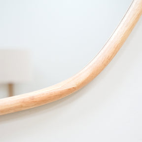 Closeup of organic natural-coloured irregular wooden wall mirror