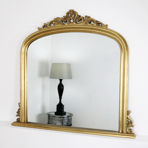 An overall view of this highly decorative, ornate overmantle mirror in a typical setting.